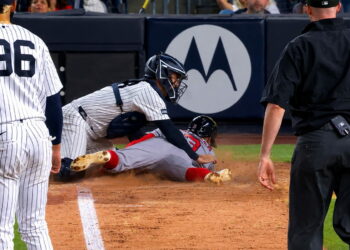 Austin Wells tagged Ceddanne Rafaela at home plate on a Bellinger throw in the Yankees' 1-0 win over the Red Sox, New York, August 28, 2026.