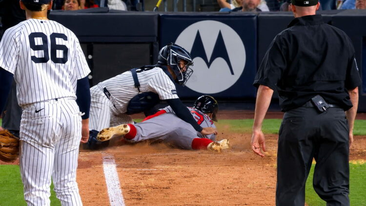 Austin Wells tagged Ceddanne Rafaela at home plate on a Bellinger throw in the Yankees' 1-0 win over the Red Sox, New York, August 28, 2026.