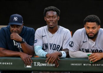 Hitting coach James Rowson, INF Jazz Chisholm and OF Heliot Ramos look at during the 6-1 Yankees win over the Orioles, Baltimore, August 20, 2026.