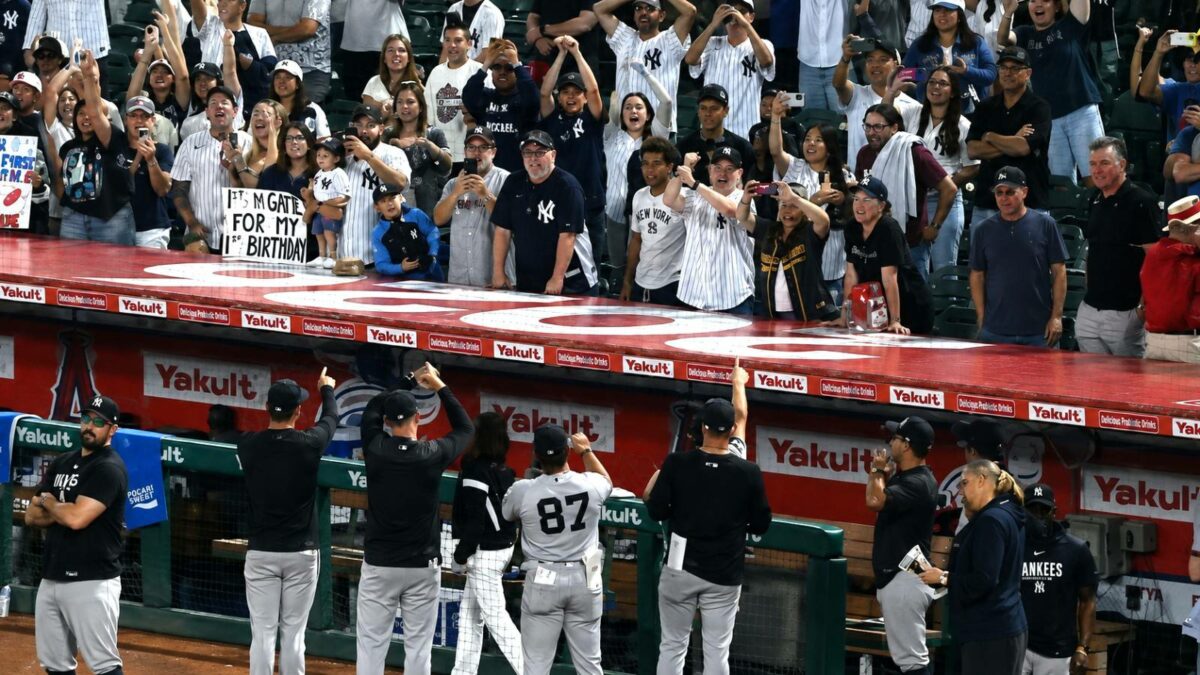 The Yankees players, manager, coach and the staff are doing the fist thing with fans after the 7-3 win over the Angels, Anaheim, September 1, 2026.