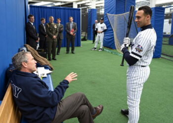 President George W. Bush talks to Derek Jeter before throwing out the ceremonial first pitch in Game 3 of the World Series between the Arizona Diamondbacks and the New York Yankees, New York, October 30, 2001.