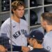 Spencer Jones talks to Judge and rice in the dugout during the Yankees' 3-2 loss to the Padres, San Diego, September 4, 2026.