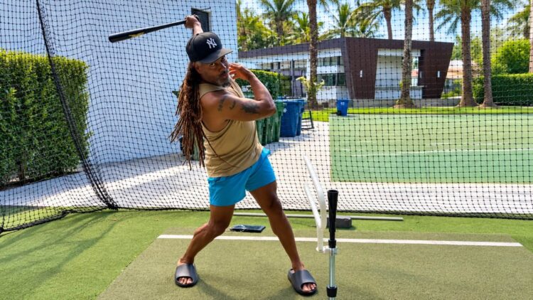 Red Sox legend Manny Ramirez wears a Yankees cap during a batting cage practice. October, 2026.