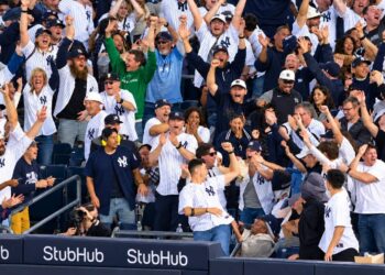 Baseball fans celebrate after the Yankees' 9-2 rout of the Red Sox at Yankee Stadium, New York, September 30, 2026 to advance to MLB ALDS.
