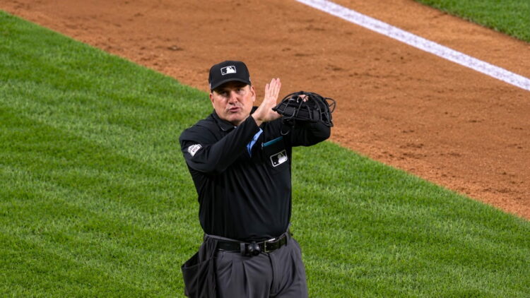 Umpire signals fan interference that overturned an Anthony Volpe HR in the Yankees' 4-3 ALDS loss to the Rays, New York, October 7, 2026.