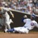 Chicago Cubs’ Dansby Swanson, right, slides safely into second as New York Yankees second baseman Gleyber Torres, left, commits a throwing error during the first inning of a baseball game in Chicago, Sunday, Sept. 8, 2024.