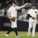 New York Yankees pitcher Carlos Rodón motions to the dugout after knocking down a line drive ball during the third inning of Game 2 of the American League baseball playoff series against the Kansas City Royals, Monday, Oct. 7, 2024, in New York.